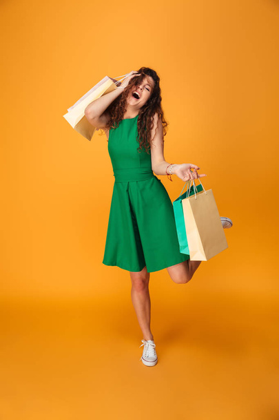 Happy young woman holding shopping bags. - Foto, Imagen