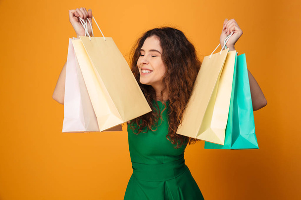 Happy young woman holding shopping bags. - Fotografie, Obrázek