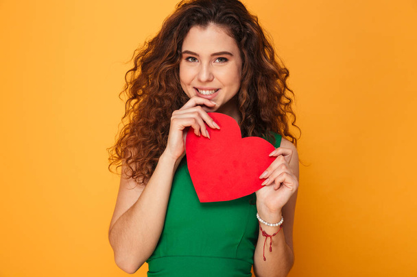 Beautiful young lady holding heart looking camera. - Foto, immagini
