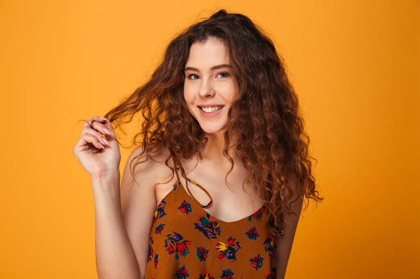 Cute young lady standing isolated over yellow background - Φωτογραφία, εικόνα