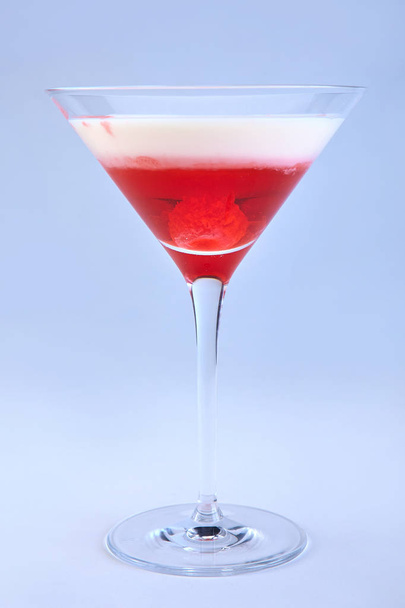 Delicious cocktail with raspberry and cream in martini glass - Fotó, kép