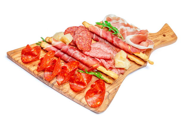 Cold smoked meat plate with pork chops, prosciutto, salami and bread sticks - Foto, imagen