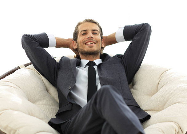 successful businessman sitting in a large comfortable chair - 写真・画像