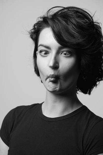 Woman pulling funny face - Foto, afbeelding