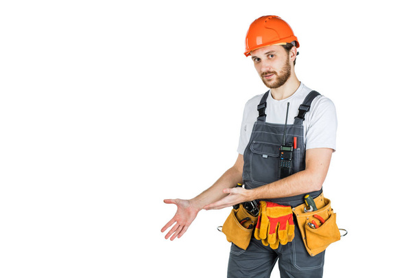 The man builder shows something. Isolated over white background - Foto, Bild