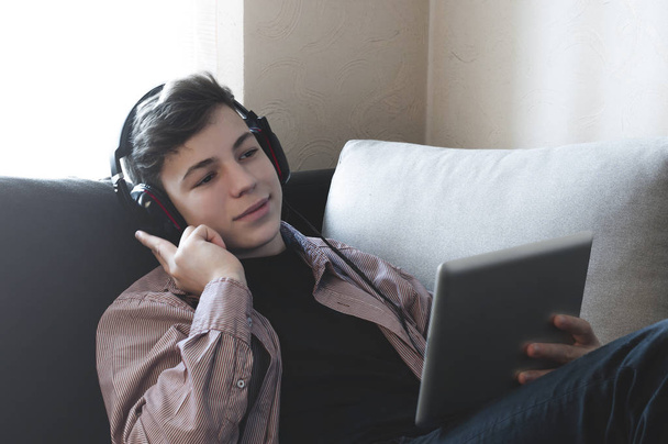 teenager in headphones listening to music - Photo, Image