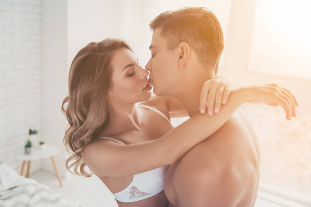 Close up portrait of horny, obsessed couple, hugging, kissing wi - 写真・画像