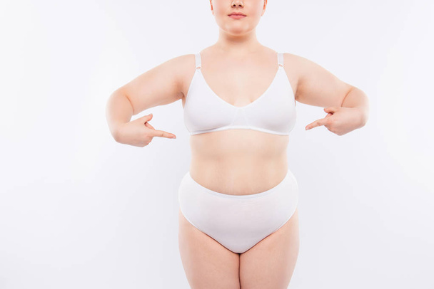 Xxl fatty chubby model wearing white lingerie is demonstrating h - Photo, Image