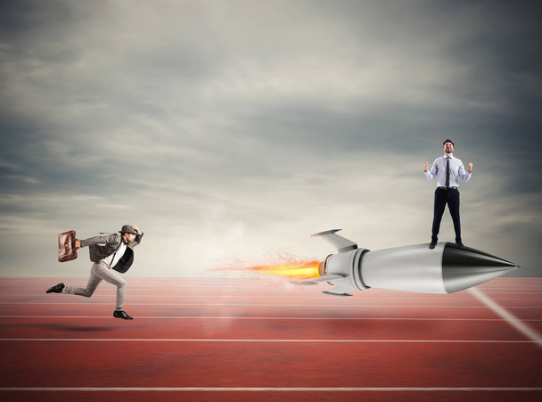 Winner businessman over a fast rocket. Concept of business competition - Photo, Image