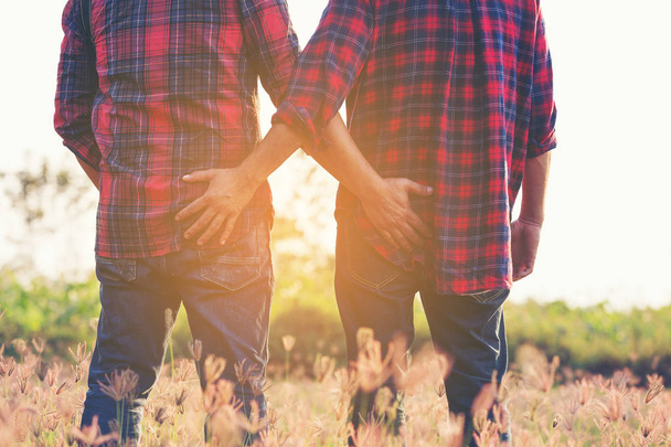 Cropped image of gay couple Catch the butt. - Фото, изображение