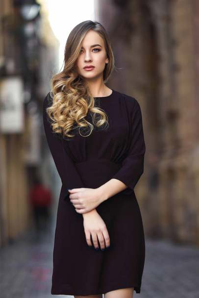 Beautiful blonde russian woman in urban background - Фото, зображення