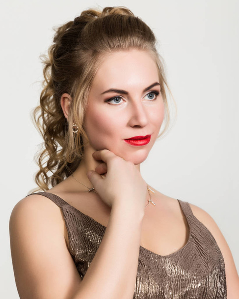 Beautiful curly woman with red lips portrait on a light background - Valokuva, kuva