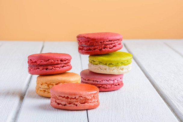 Different types color of macaroons on white wooden background - Photo, Image
