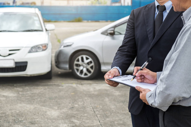 Insurance Agent examine Damaged Car and customer filing signatur - Photo, Image