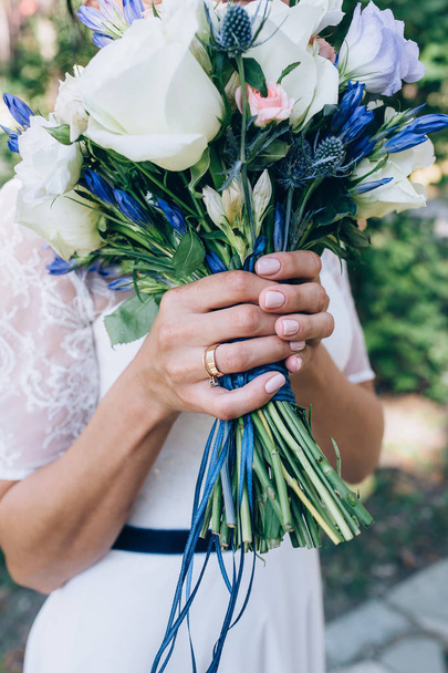 the bride is holding a wedding bouquet of beautiful roses - Photo, Image