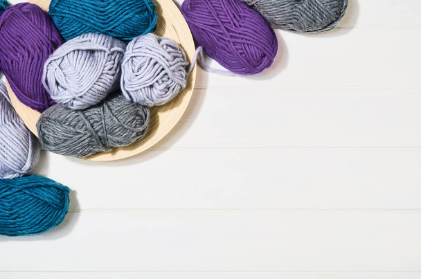 Knitting accessories top view on white wooden background - Φωτογραφία, εικόνα