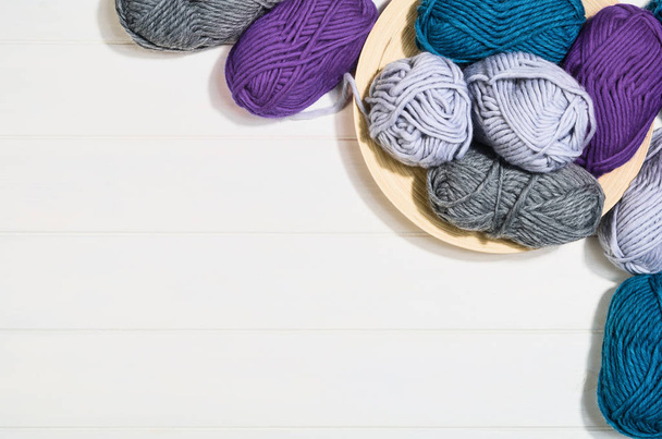 Knitting accessories top view on white wooden background - Φωτογραφία, εικόνα