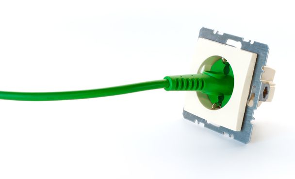 Green power cable plugged into wall outlet without cover - Photo, Image