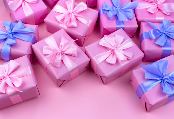 Decorative holiday gift boxes with pink color on pink background. Flat flat top view - Photo, Image