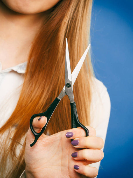 Dangerous lady showing scissors. - Photo, image