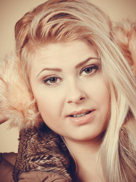 Blonde woman in winter earmuffs and jacket. - Foto, imagen