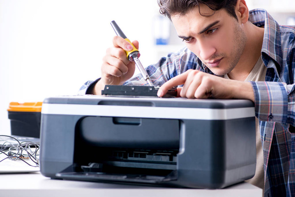 Hardware repairman repairing broken printer fax machine - Photo, Image