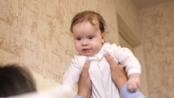 Bebé en manos del Papa ríe alegremente y gotas babean. Movimiento lento
. - Imágenes, Vídeo