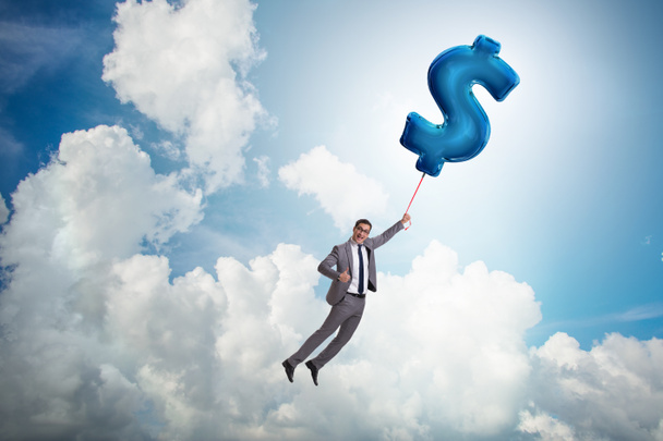 Biznesmen latający na znak dolara nadmuchiwany balon - Zdjęcie, obraz