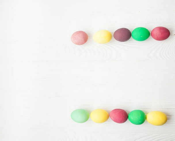 Colorful Easter eggs on white wooden background. - 写真・画像