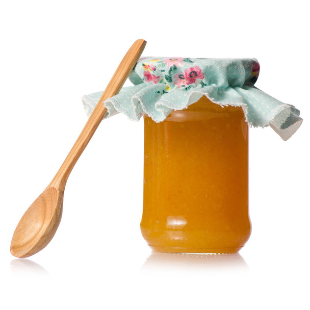 Orange apricot peachy jam in a jar cover wooden spoon - Zdjęcie, obraz