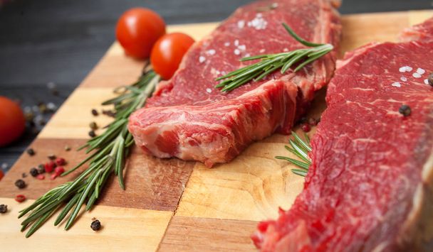 Raw ribeye beef steak cooking with ingredients. Top view with copy space - Foto, Imagem