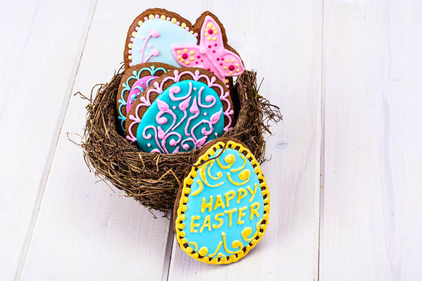 Symbols of the holiday Easter-nest, eggs, cookies - Photo, Image