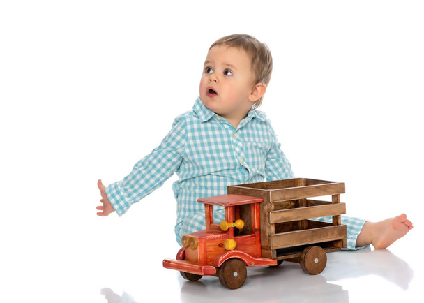 A little boy is playing with a toy car. - Fotoğraf, Görsel