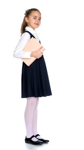 Girl schoolgirl with book. - Valokuva, kuva