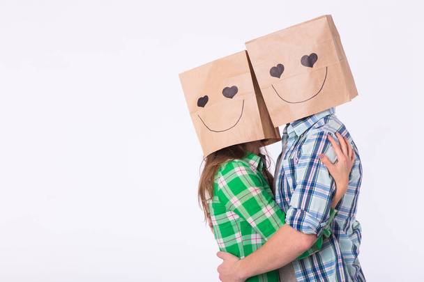 Valentines day concept - Young love couple with bags over heads on white background - Photo, Image