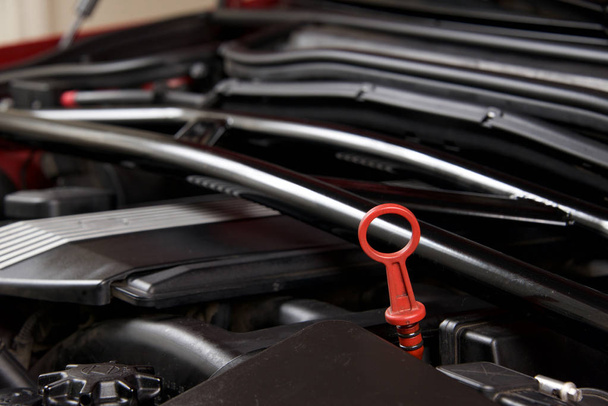 Close up of an oil dipstick in a clean car engine bay - Photo, Image