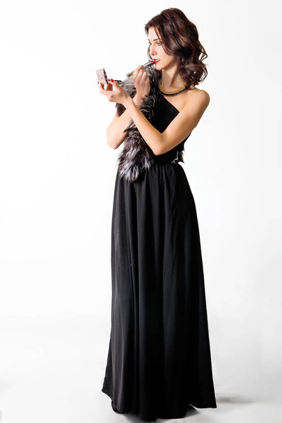 beautiful chic woman in black evening dress and fur collar color - Valokuva, kuva