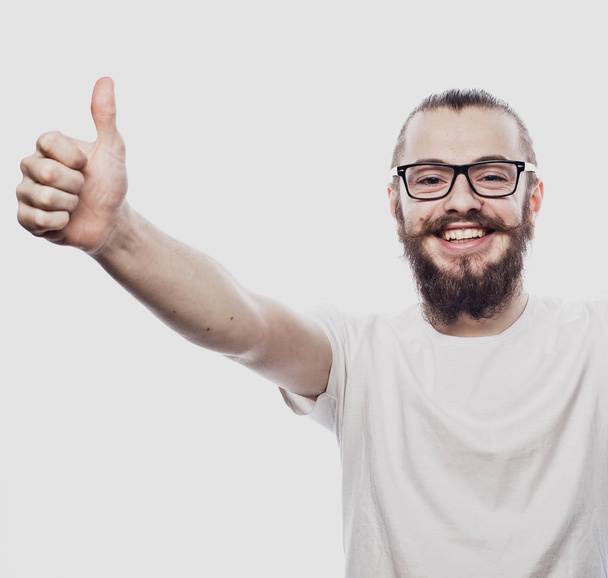 Portrait of a cheerful young bearded man showing okay gesture isolated on the white background - Φωτογραφία, εικόνα