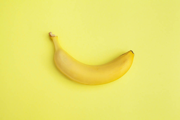 yellow fresh banana on a yellow background - Fotografie, Obrázek