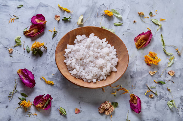 Composition of spa treatment on white background. Sea salt and flowers background, close up, top view, selective focus. - Fotoğraf, Görsel