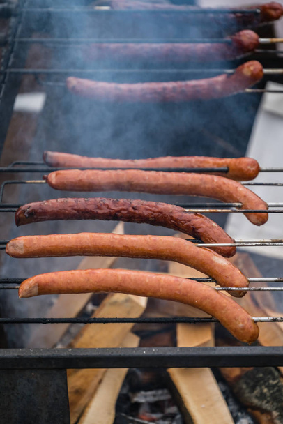 Pork and beef sausages being grilled - Valokuva, kuva