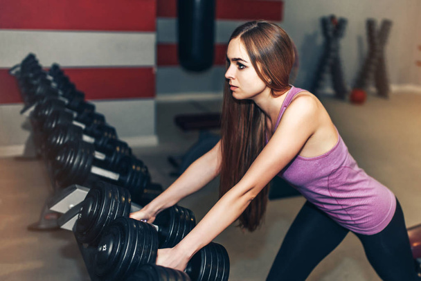 active sporty girl with long hair training in the gym - 写真・画像