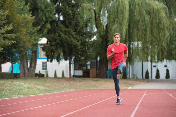 Young Male Athlete Running on Track - Φωτογραφία, εικόνα