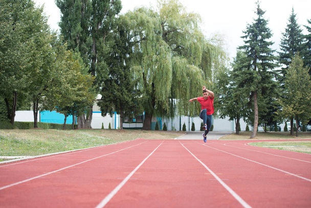 Young Male Athlete Running on Track - Фото, зображення