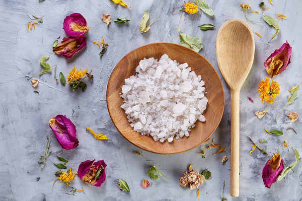 Composition of spa treatment on white background. Sea salt and flowers background, close up, top view, selective focus. - Fotoğraf, Görsel