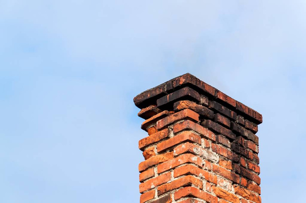 Old brick chimney. Chimney with sky in the background. Eco-friendly heating of a family house. - Photo, Image