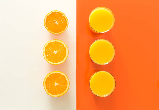 Orange juice and fruits on the orange-white glass  - Photo, Image