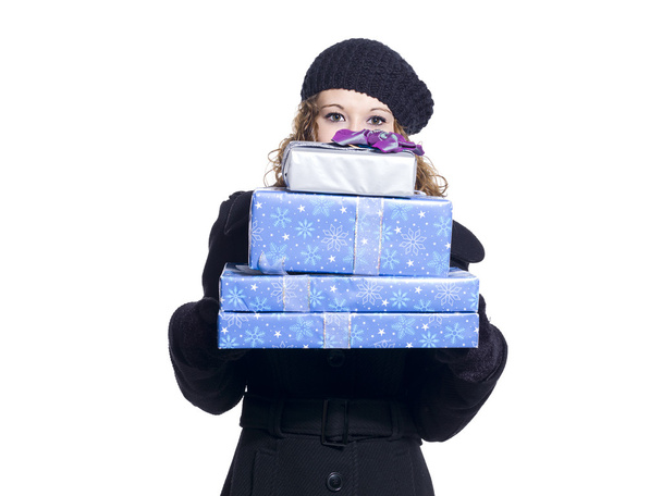 woman holding a stack of christmas presents - Фото, изображение