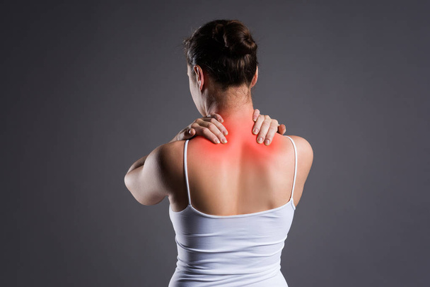 Neck pain, woman with backache on gray background - Foto, Imagen