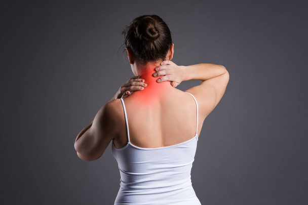 Neck pain, woman with backache on gray background - Foto, Imagem
